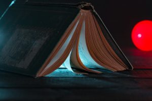 An overturned book, propped like a tent, light emitting from within.