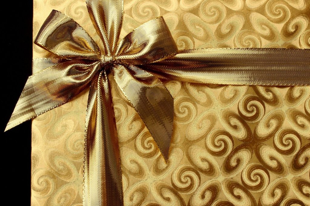 A golden present tied with a golden ribbon.