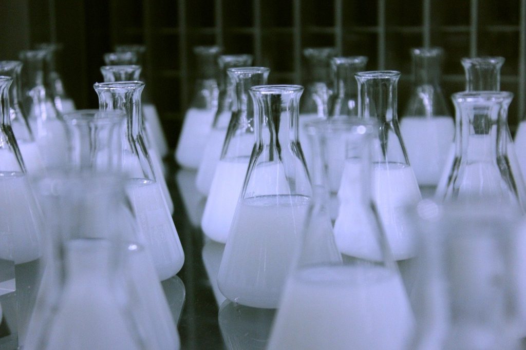 Laboratory flasks filled with white liquid