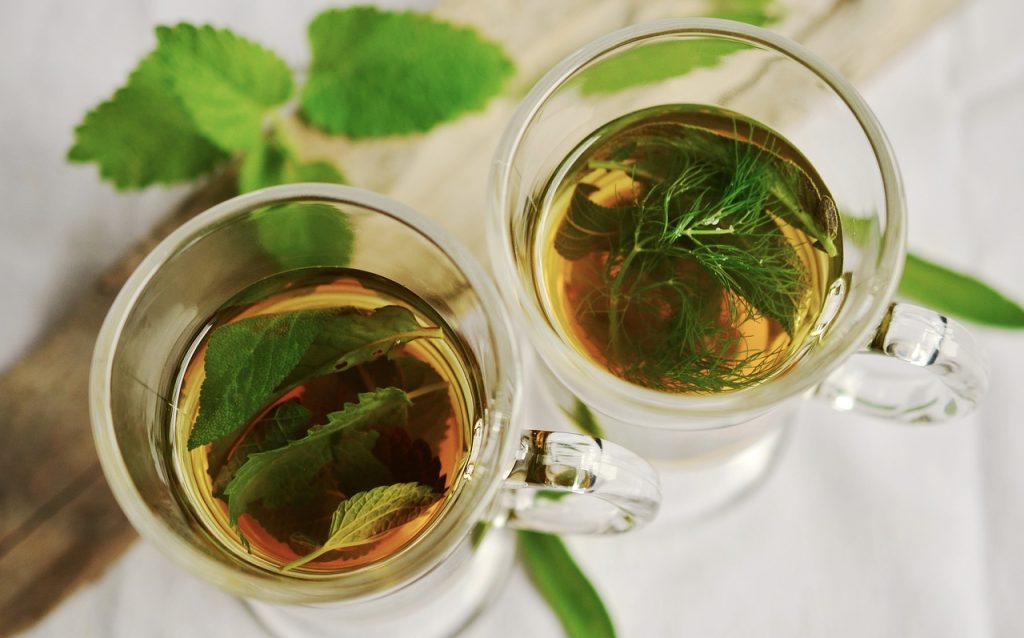 Two glass mugs seen from above, filled with herbal tea.