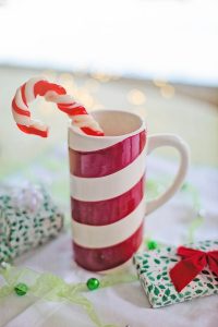 A peppermint mug with a candy cane inside.