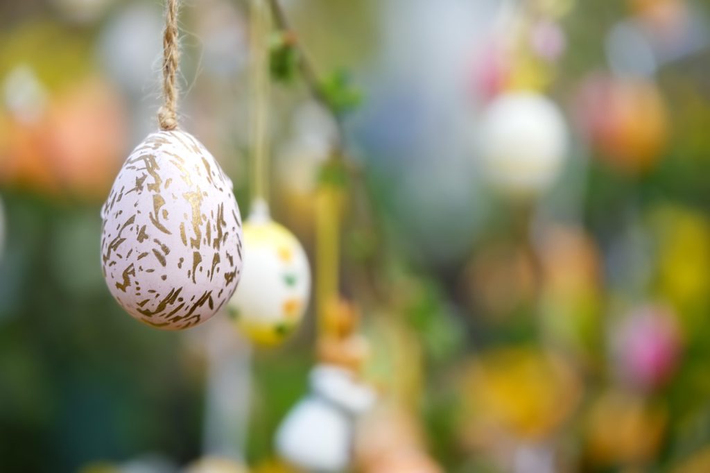Colourful eggs hang upon a rope.