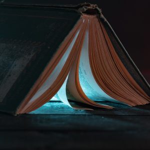 An overturned book, propped like a tent, light emitting from within.