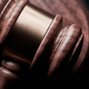 An auctioneer's gavel against a black background.