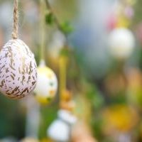 Colourful eggs hang upon a rope.