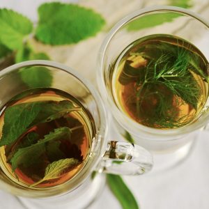 Two glass mugs seen from above, filled with herbal tea.