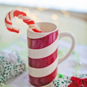 A peppermint mug with a candy cane inside.
